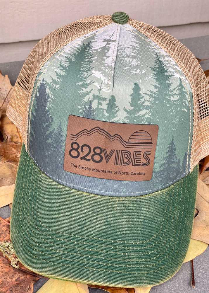 Green and beige cap with '828 Vibes' logo on a leafy background