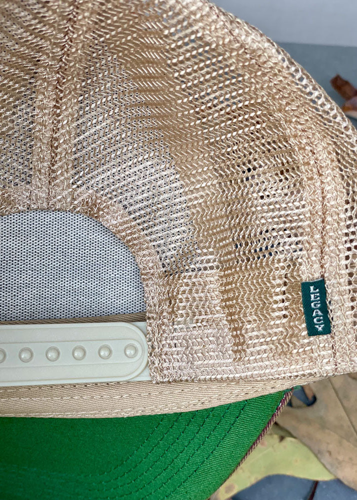 Close-up of a mesh cap with a brand tag on a blurred background