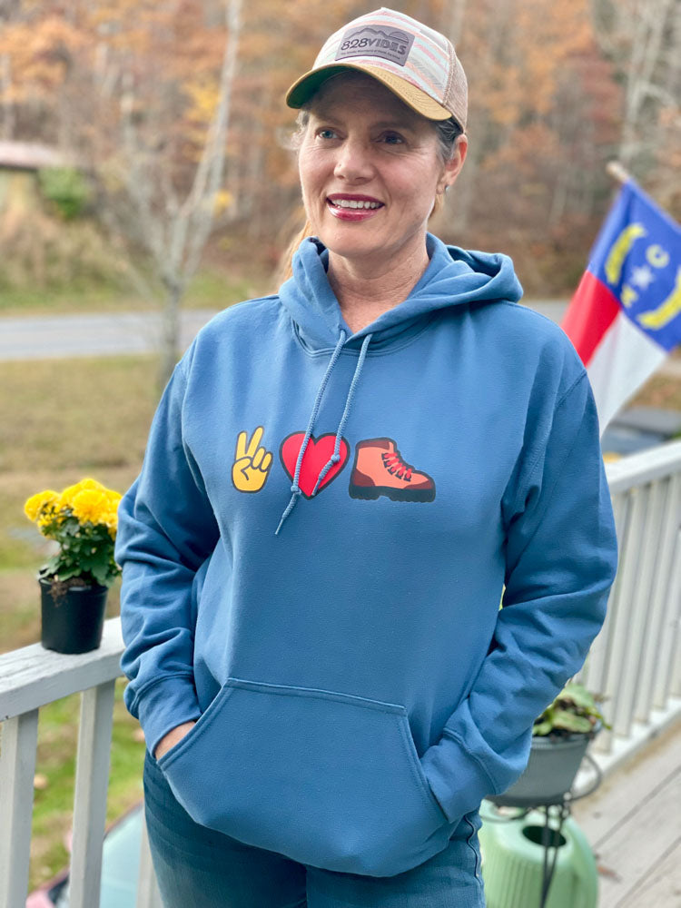 Person wearing a blue hoodie with symbols on a deck